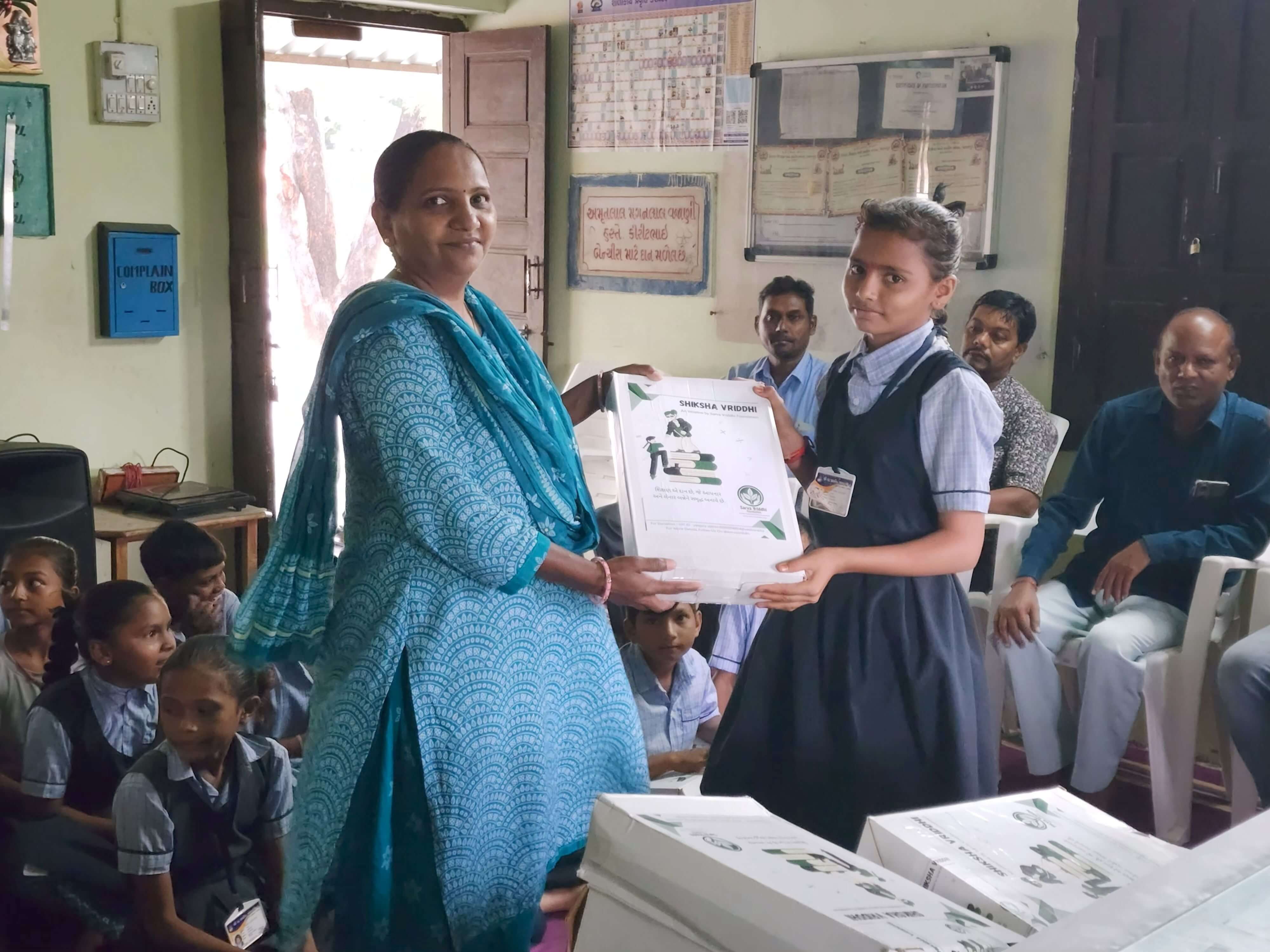 Child receiving an educational kit in 2025